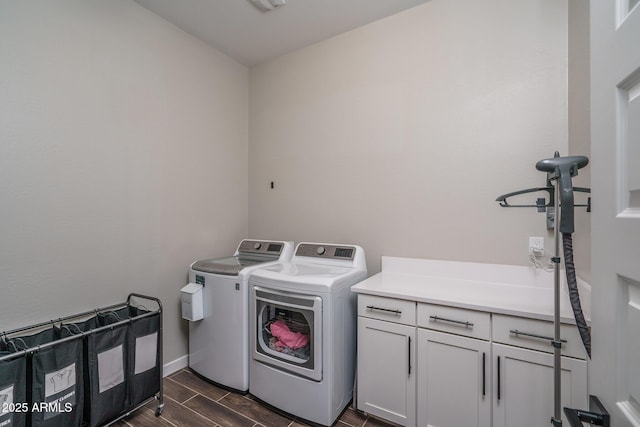 12702 W Sierra Vista Dr, Glendale, AZ 85307 - laundry room with wood finish floors, cabinet space, washer and clothes dryer, and baseboards