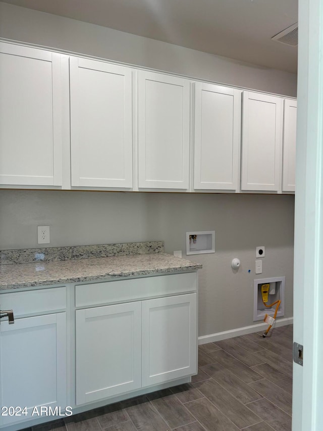 washroom with hookup for a washing machine, hookup for a gas dryer, dark hardwood / wood-style floors, cabinets, and electric dryer hookup