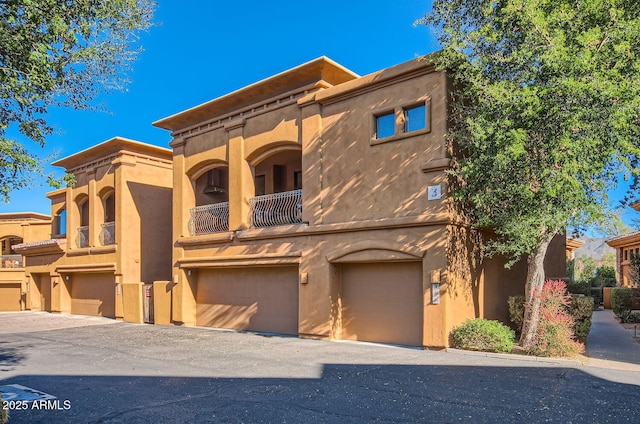 view of front facade featuring a balcony and a garage