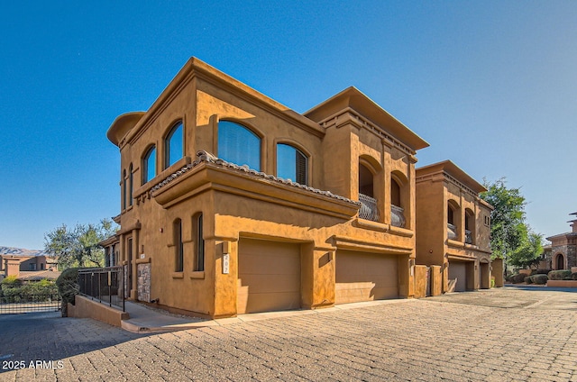 mediterranean / spanish home with a garage