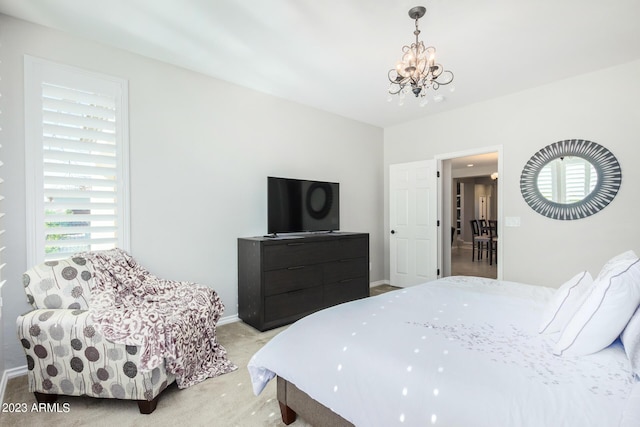 carpeted bedroom featuring a chandelier