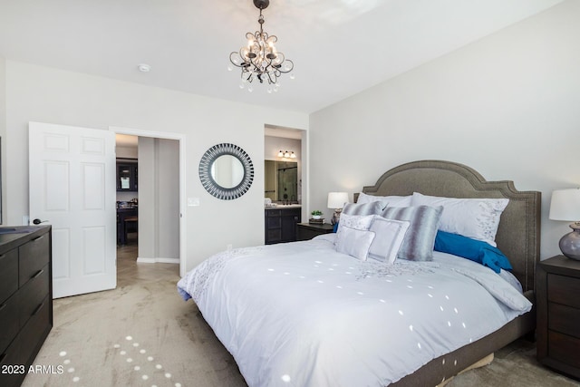 carpeted bedroom with connected bathroom and a chandelier