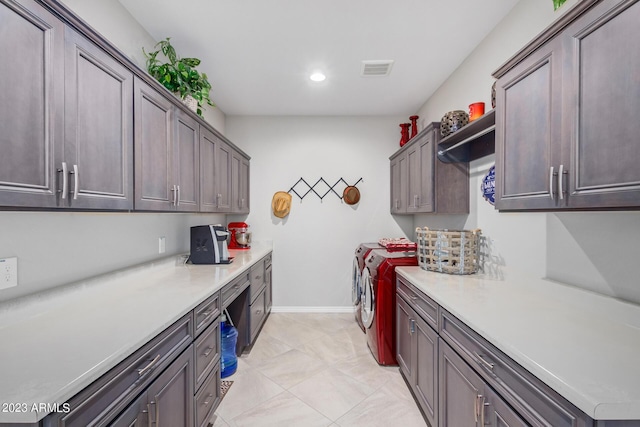 laundry room featuring cabinets and washer and clothes dryer