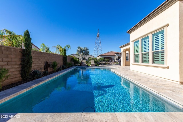 view of swimming pool with a patio area