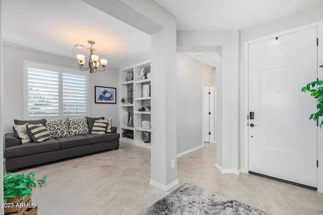 tiled entrance foyer featuring an inviting chandelier