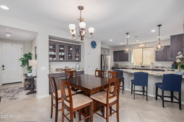 dining room featuring light tile patterned flooring, sink, and a chandelier