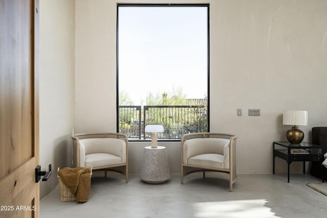 sitting room featuring concrete floors