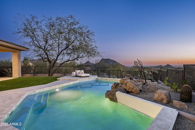 view of pool featuring a mountain view, a fenced backyard, and a fenced in pool