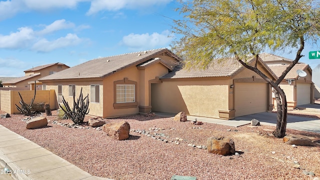 ranch-style home featuring stucco siding, an attached garage, fence, driveway, and a tiled roof