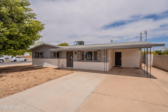 1654 E 2nd St, Mesa, AZ 85203 - ranch-style home featuring brick siding, driveway, and a carport