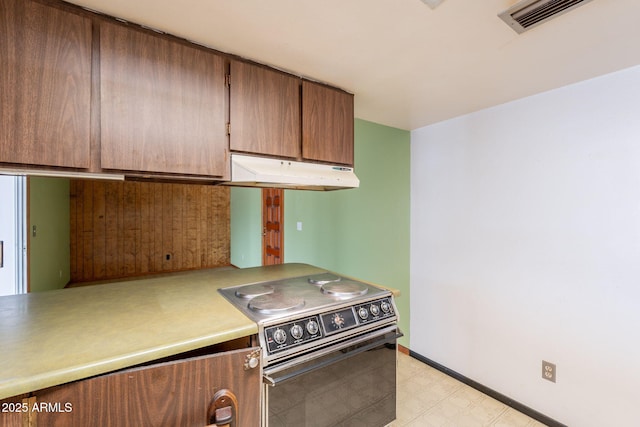 1654 E 2nd St, Mesa, AZ 85203 - kitchen with range with electric stovetop, under cabinet range hood, light floors, light countertops, and baseboards