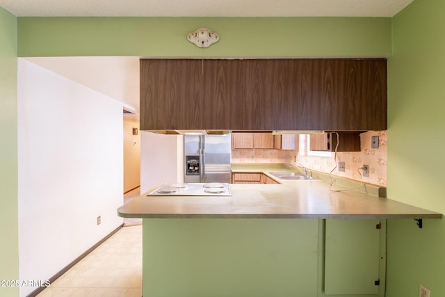 1654 E 2nd St, Mesa, AZ 85203 - kitchen with stainless steel fridge, light flooring, a sink, green cabinetry, and a peninsula