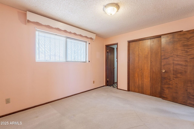1654 E 2nd St, Mesa, AZ 85203 - unfurnished bedroom featuring carpet, a closet, and a textured ceiling