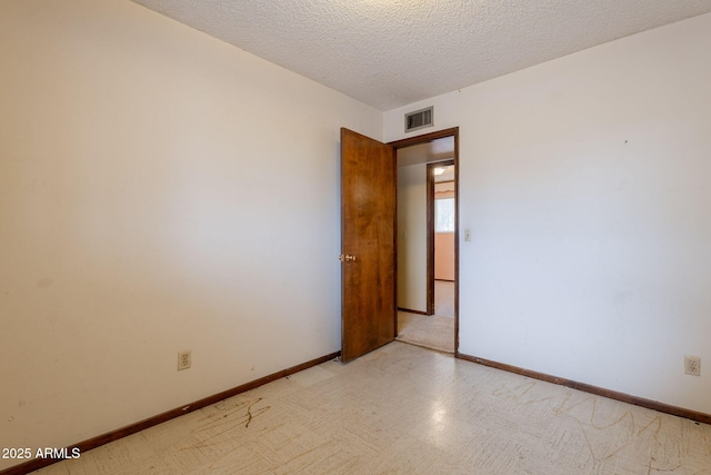 1654 E 2nd St, Mesa, AZ 85203 - unfurnished room with baseboards and a textured ceiling