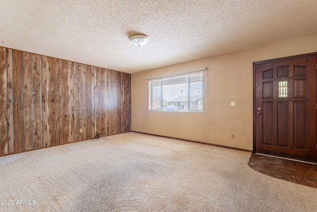 1654 E 2nd St, Mesa, AZ 85203 - foyer entrance featuring wooden walls, carpet floors, baseboards, and a textured ceiling