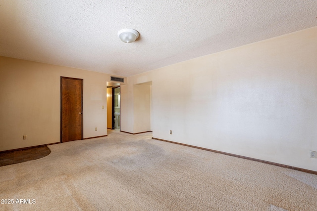 1654 E 2nd St, Mesa, AZ 85203 - unfurnished room with light carpet, baseboards, and a textured ceiling