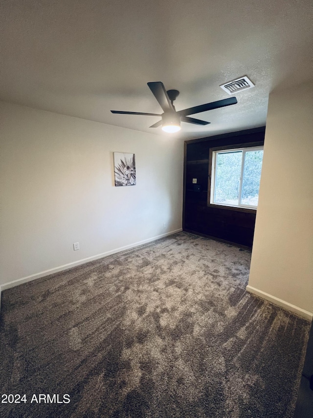 carpeted spare room with a textured ceiling