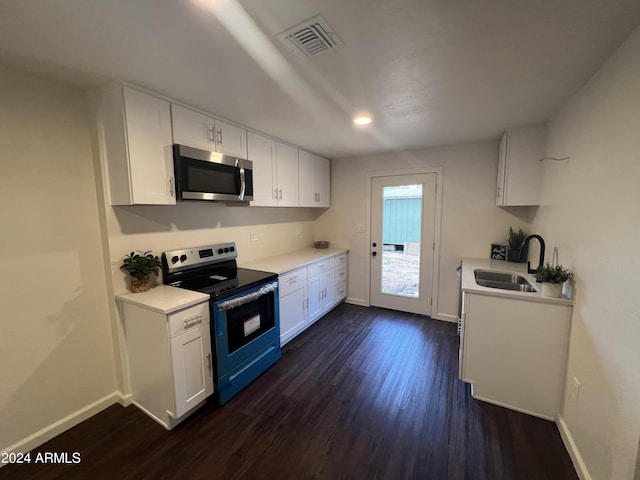 kitchen with dark hardwood / wood-style floors, sink, stainless steel appliances, and white cabinetry