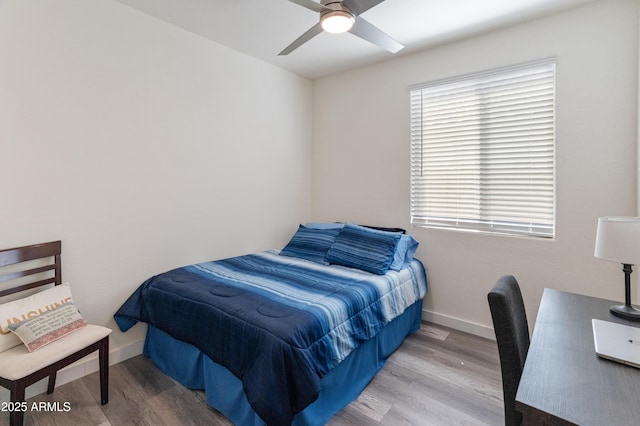 24638 N 144th Ave, Surprise, AZ 85387 - bedroom featuring wood finished floors, an office area, baseboards, and ceiling fan
