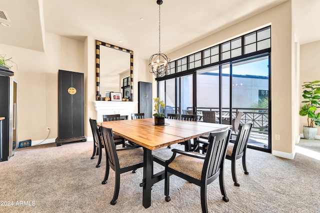 carpeted dining area featuring a chandelier