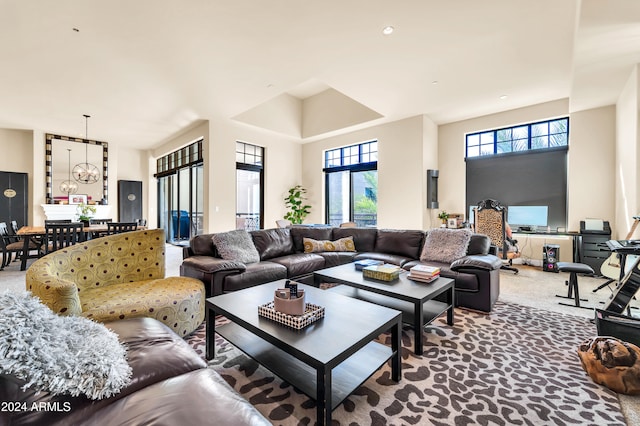 living room featuring a towering ceiling and carpet flooring