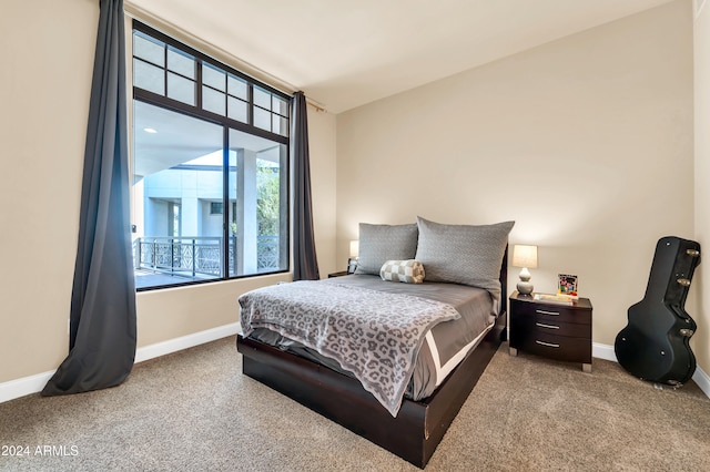 carpeted bedroom with lofted ceiling