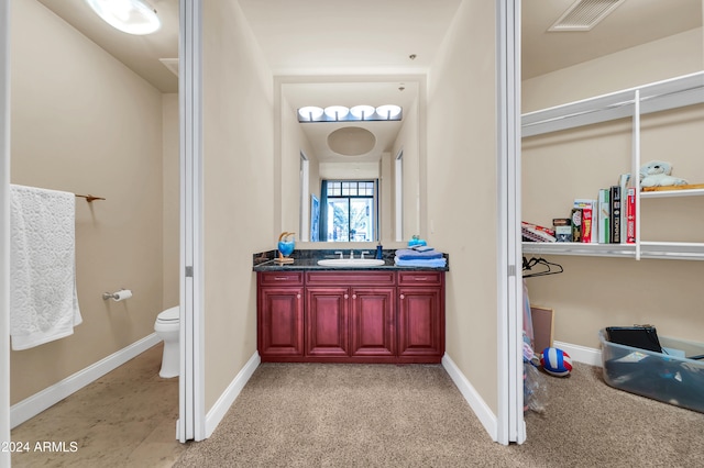 bathroom with toilet and vanity