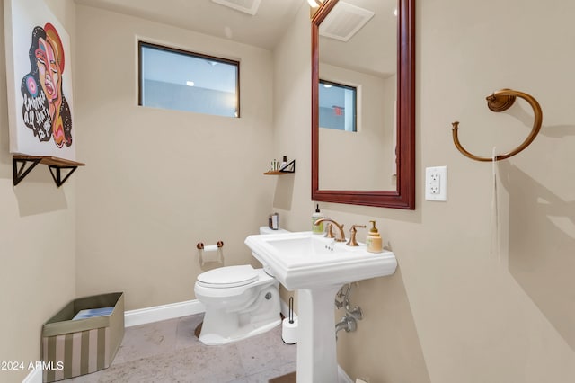 bathroom with toilet and tile patterned flooring