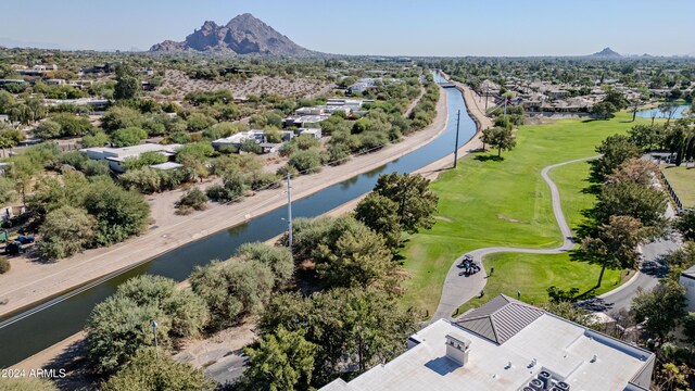 birds eye view of property with a water and mountain view