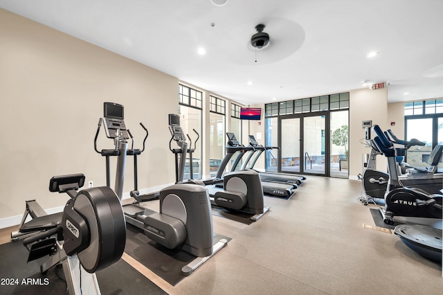 exercise room with ceiling fan and expansive windows