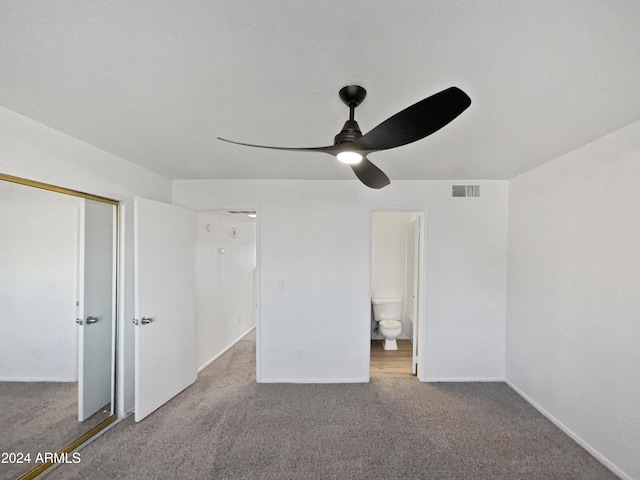 unfurnished bedroom with light colored carpet, ceiling fan, ensuite bath, and a closet