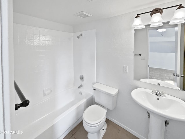 bathroom featuring tile patterned floors, toilet, and tiled shower / bath