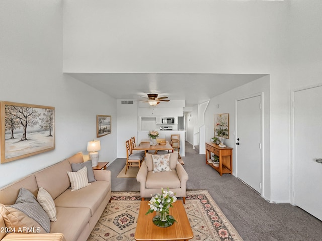 carpeted living room featuring ceiling fan