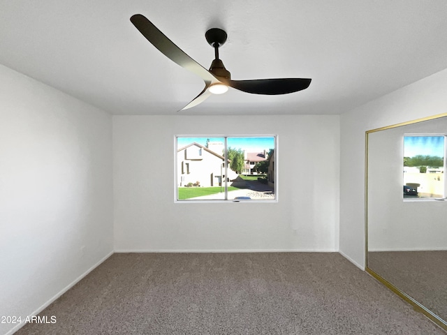 empty room with carpet floors and ceiling fan