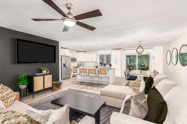 8437 E Bonnie Rose Ave, Scottsdale, AZ 85250 - living area with light wood-style floors, ceiling fan, and recessed lighting