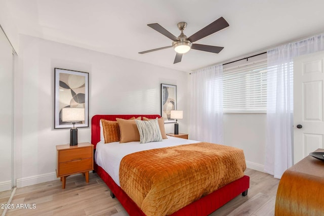 8437 E Bonnie Rose Ave, Scottsdale, AZ 85250 - bedroom with light wood-type flooring, baseboards, and ceiling fan