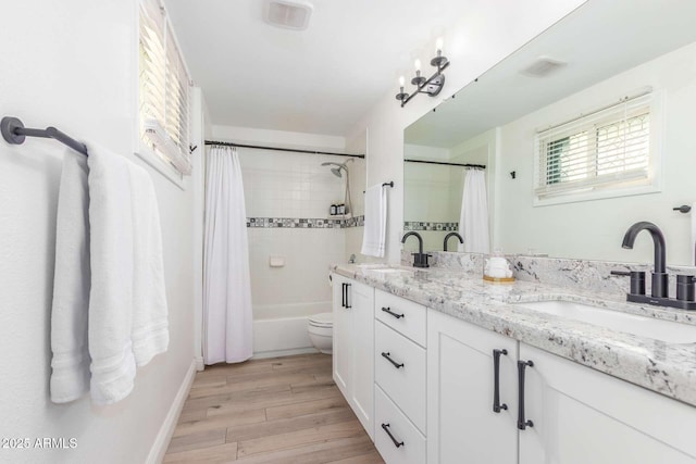 8437 E Bonnie Rose Ave, Scottsdale, AZ 85250 - bathroom with wood finished floors, double vanity, toilet, shower / tub combo with curtain, and baseboards