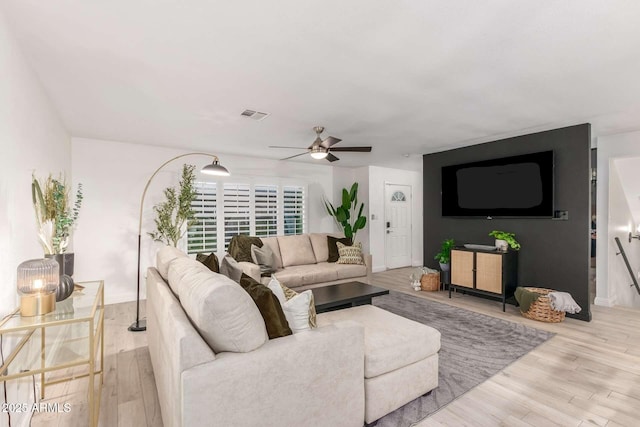8437 E Bonnie Rose Ave, Scottsdale, AZ 85250 - living area featuring ceiling fan, wood finished floors, and baseboards