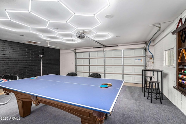 8437 E Bonnie Rose Ave, Scottsdale, AZ 85250 - recreation room featuring a garage, brick wall, and carpet floors