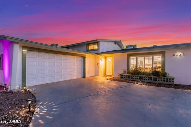 8437 E Bonnie Rose Ave, Scottsdale, AZ 85250 - view of front of home with driveway, a garage, and stucco siding
