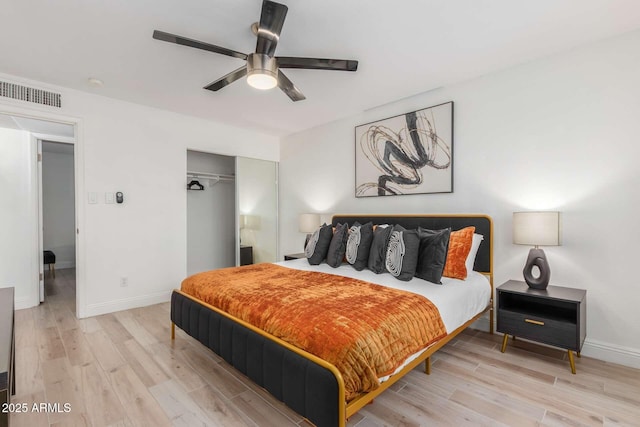 8437 E Bonnie Rose Ave, Scottsdale, AZ 85250 - bedroom with a closet, wood finished floors, baseboards, and ceiling fan