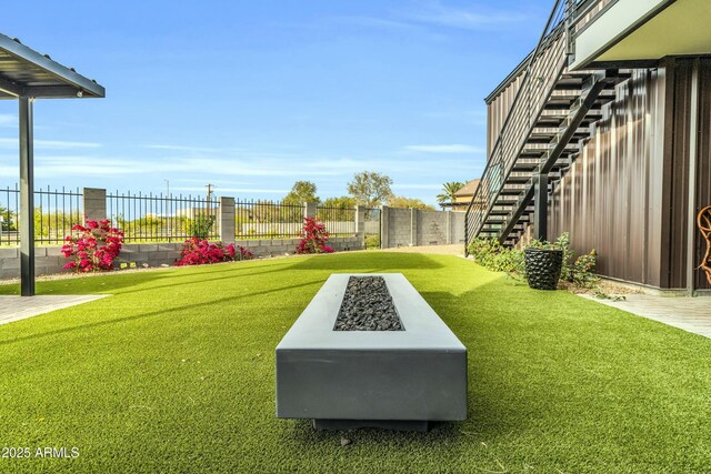 908 W Caldwell St, Phoenix, AZ 85041 - view of yard featuring an outdoor fire pit, fence, and stairway