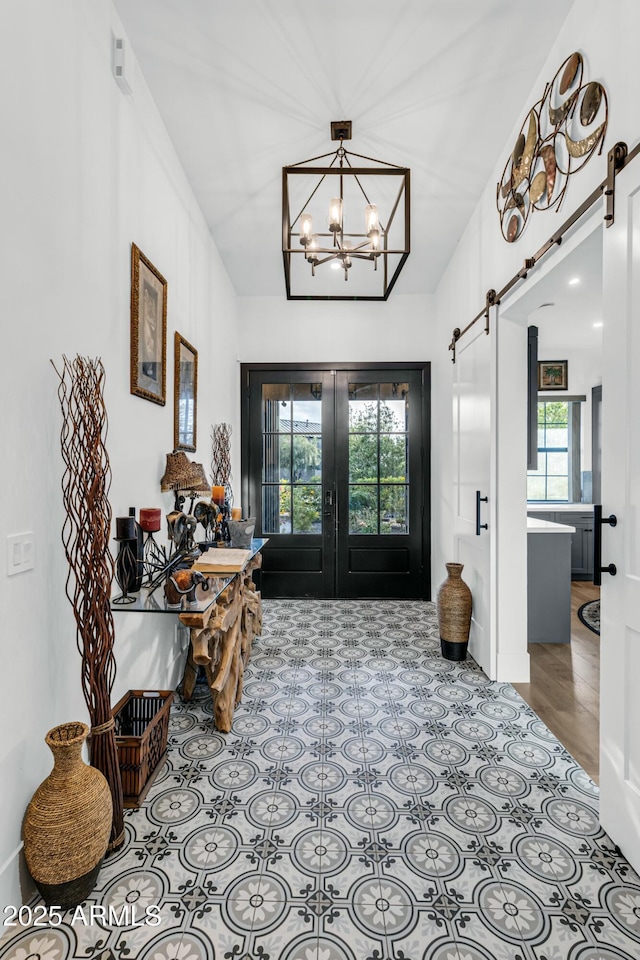 908 W Caldwell St, Phoenix, AZ 85041 - entrance foyer featuring a barn door, french doors, and an inviting chandelier