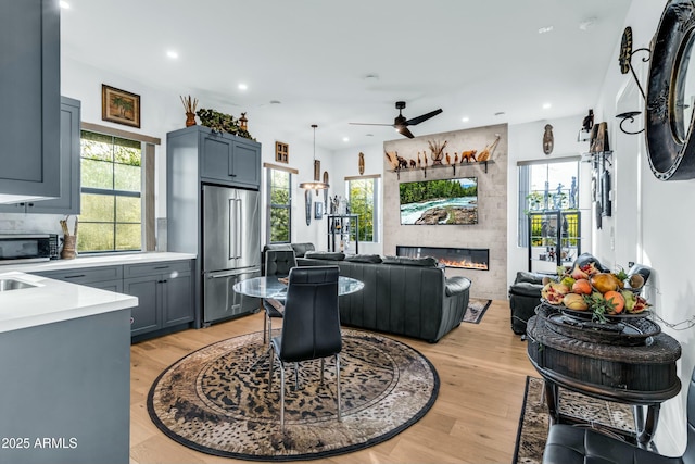 908 W Caldwell St, Phoenix, AZ 85041 - interior space with light wood finished floors, appliances with stainless steel finishes, ceiling fan, and light countertops