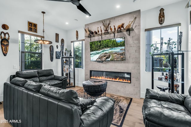 908 W Caldwell St, Phoenix, AZ 85041 - living area featuring a ceiling fan, plenty of natural light, light wood-style floors, and a fireplace