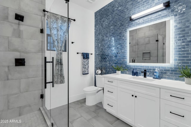908 W Caldwell St, Phoenix, AZ 85041 - bathroom with toilet, a stall shower, decorative backsplash, and vanity