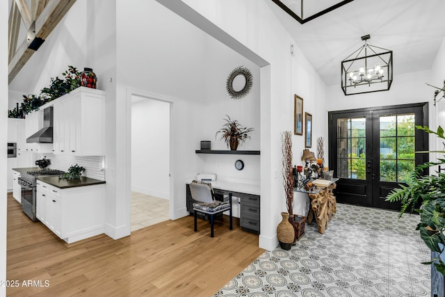 908 W Caldwell St, Phoenix, AZ 85041 - entryway with a notable chandelier, baseboards, french doors, light wood-style floors, and high vaulted ceiling