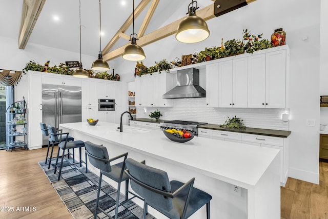 908 W Caldwell St, Phoenix, AZ 85041 - kitchen with wall chimney range hood, light wood-type flooring, a sink, and appliances with stainless steel finishes