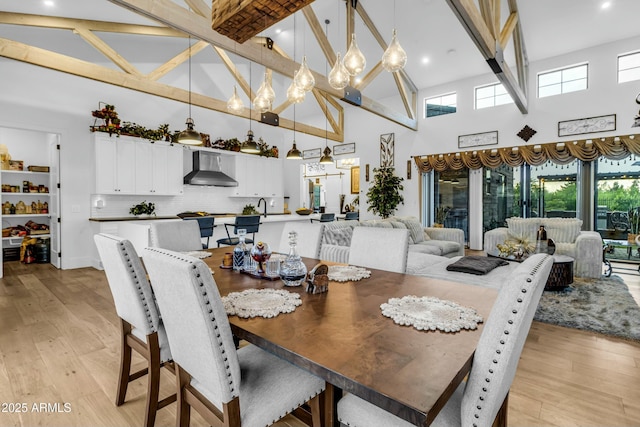 908 W Caldwell St, Phoenix, AZ 85041 - dining space with high vaulted ceiling, a notable chandelier, and light wood-style floors