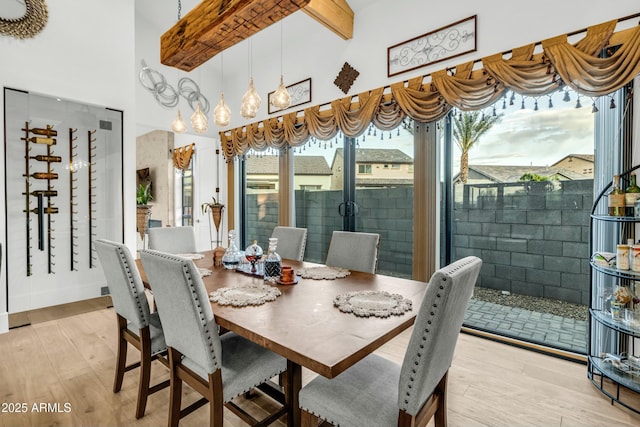 908 W Caldwell St, Phoenix, AZ 85041 - dining space with light wood-style flooring, a high ceiling, and beam ceiling
